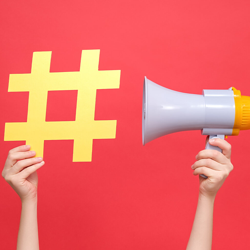 Image of hands holding a hash symbol and a bullhorn