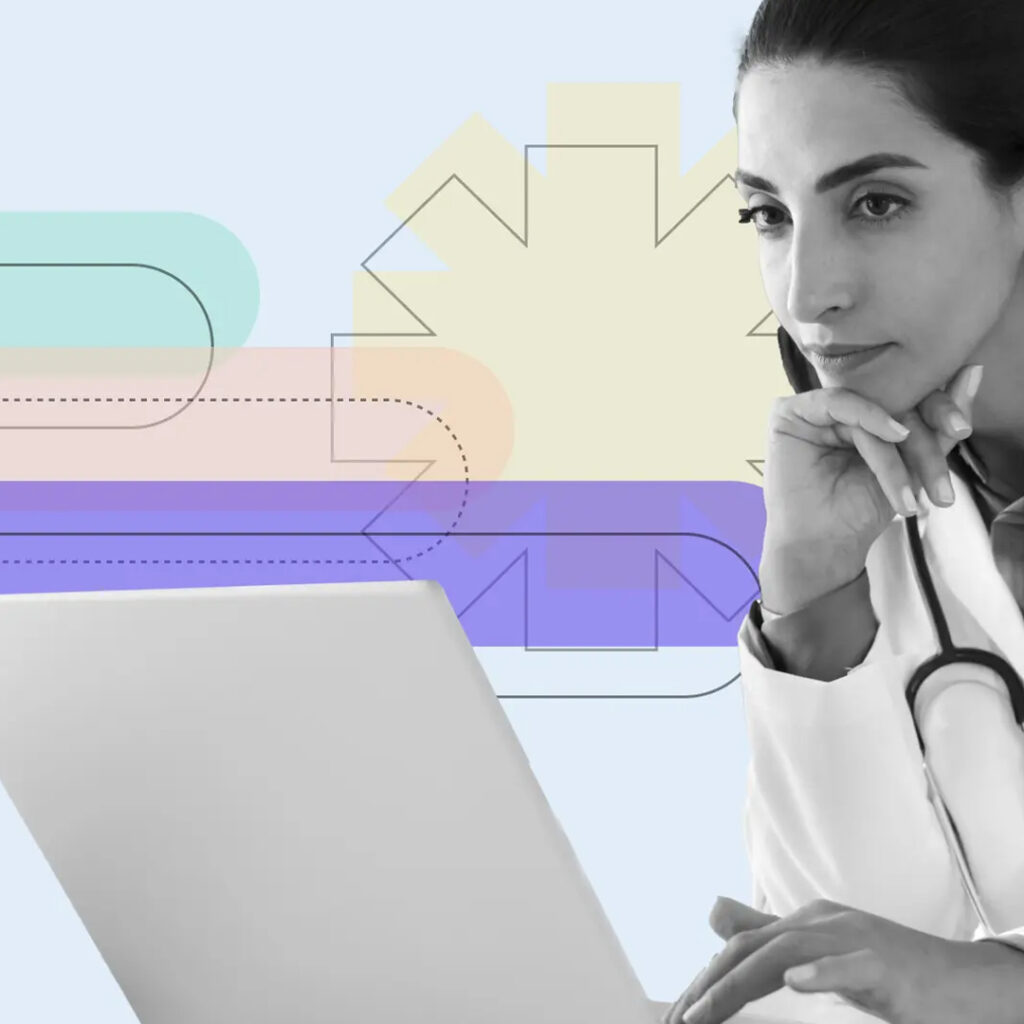 Doctor with stethoscope working on laptop with medical graphics in background